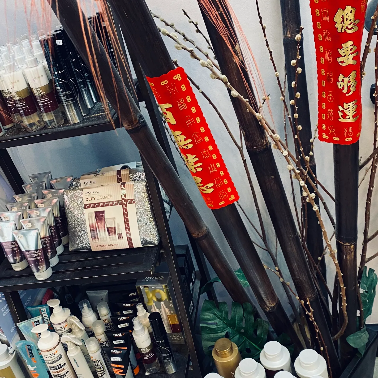 Shelves of hair-care products beside bamboo and festive red banners